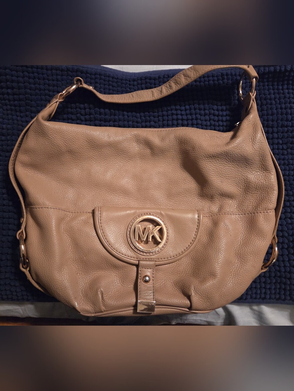 Michael Kors Fulton Large Pebbled Leather Hobo Bag in a tan color.